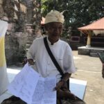Local monk explaining the meaning of Swastika symbol to us